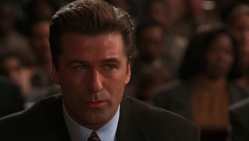 Movie still from “Ghosts of Mississippi” (1996), directed by Rob Reiner – A person wearing a suit and tie; Close Up shot, Over the shoulder angle