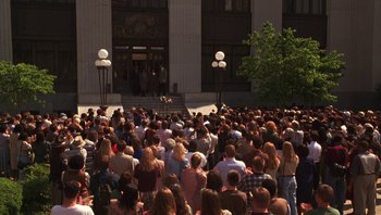Movie still from “Ghosts of Mississippi” (1996), directed by Rob Reiner – A crowd of people gathered in front of a building; Extreme Wide shot, High angle