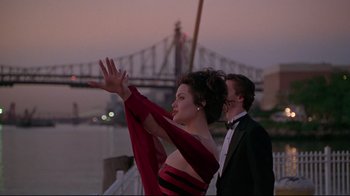 Movie still from “Gia” (1998), directed by Michael Cristofer – A man and a woman dressed in formal wear; Medium shot, Over the shoulder angle