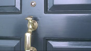 Movie still from “Gia” (1998), directed by Michael Cristofer – A door handle on a blue door; Extreme Close Up shot, High angle