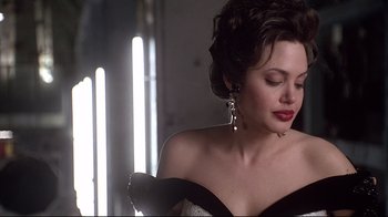 Movie still from “Gia” (1998), directed by Michael Cristofer – A woman in a black and white dress with a black bow; Close Up shot, Over the shoulder angle