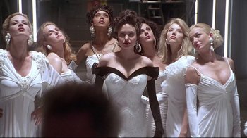 Movie still from “Gia” (1998), directed by Michael Cristofer – A group of women in white dresses posing for a picture; Medium shot, Low angle