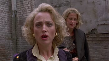 Movie still from “Gia” (1998), directed by Michael Cristofer – Two women are standing next to a brick wall; Close Up shot, Low angle