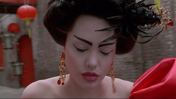 Movie still from “Gia” (1998), directed by Michael Cristofer – A woman with long black hair wearing a red dress; Close Up shot, Overhead angle