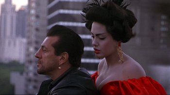 Movie still from “Gia” (1998), directed by Michael Cristofer – A man and a woman are standing next to each other; Close Up shot, Over the shoulder angle