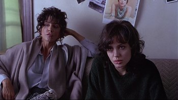 Movie still from “Gia” (1998), directed by Michael Cristofer – Two women sitting next to each other in a room; Medium shot, Low angle