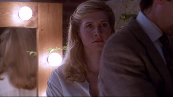 Movie still from “Gia” (1998), directed by Michael Cristofer – A woman with long blonde hair is looking at the camera; Close Up shot, Over the shoulder angle