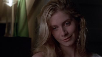 Movie still from “Gia” (1998), directed by Michael Cristofer – A beautiful blonde woman with long blonde hair; Close Up shot, Over the shoulder angle