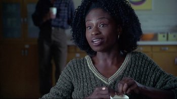 Movie still from “Gia” (1998), directed by Michael Cristofer – A person sitting at a table holding a cup; Close Up shot, Over the shoulder angle