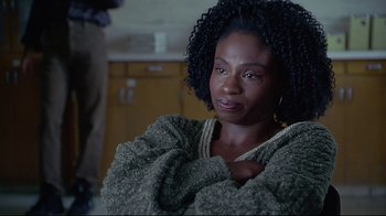 Movie still from “Gia” (1998), directed by Michael Cristofer – A person wearing a sweater and looking at the camera; Close Up shot, Over the shoulder angle