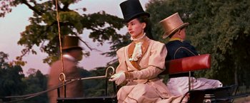 Movie still from “Gigi” (1958), directed by Vincente Minnelli – A woman sitting on top of a horse drawn carriage; Medium shot, Low angle