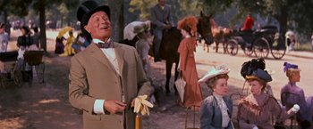 Movie still from “Gigi” (1958), directed by Vincente Minnelli – A man and a woman standing next to each other on a dirt road; Medium shot, Low angle