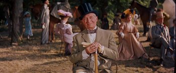Movie still from “Gigi” (1958), directed by Vincente Minnelli – An older man wearing a top hat holding a banana; Medium shot, Low angle