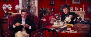 Movie still from “Gigi” (1958), directed by Vincente Minnelli – A man and a woman sitting in a living room; Medium shot, High angle