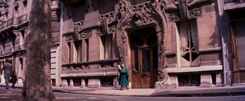 Movie still from “Gigi” (1958), directed by Vincente Minnelli – A woman standing in front of an ornate building; Extreme Wide shot, Low angle