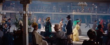 Movie still from “Gigi” (1958), directed by Vincente Minnelli – A group of people dressed in period clothing; Wide shot, High angle