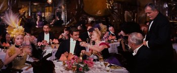 Movie still from “Gigi” (1958), directed by Vincente Minnelli – A man and a woman are sitting at a dinner table; Medium shot, High angle