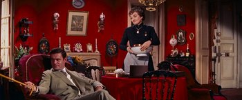 Movie still from “Gigi” (1958), directed by Vincente Minnelli – A woman in a black shirt is holding a white bowl; Medium shot, Low angle