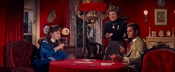 Movie still from “Gigi” (1958), directed by Vincente Minnelli – A group of people sitting at a table with food; Medium shot, High angle