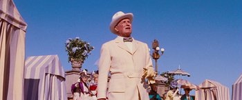 Movie still from “Gigi” (1958), directed by Vincente Minnelli – An older man in a white suit and hat; Medium shot, Low angle