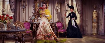 Movie still from “Gigi” (1958), directed by Vincente Minnelli – A woman in a yellow and white dress holding a bouquet of flowers; Wide shot, Low angle