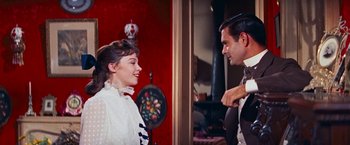 Movie still from “Gigi” (1958), directed by Vincente Minnelli – A man and a woman talking in front of a fireplace; Medium shot, Over the shoulder angle