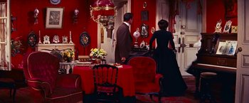 Movie still from “Gigi” (1958), directed by Vincente Minnelli – A man and a woman standing in a living room; Wide shot, High angle