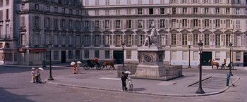 Movie still from “Gigi” (1958), directed by Vincente Minnelli – A man and a woman standing on the side of a road; Extreme Wide shot, High angle