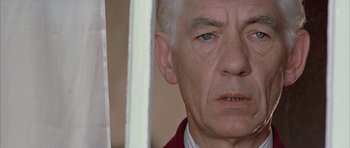Movie still from “Gods and Monsters” (1998), directed by Bill Condon – An older man with white hair and blue eyes looking at the camera; Close Up shot, Low angle