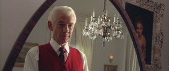 Movie still from “Gods and Monsters” (1998), directed by Bill Condon – An older man standing in front of a chandelier; Close Up shot, Low angle