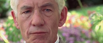 Movie still from “Gods and Monsters” (1998), directed by Bill Condon – An old man with a white beard and blue eyes looking at the camera; Extreme Close Up shot, Low angle