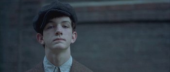 Movie still from “Gods and Monsters” (1998), directed by Bill Condon – A young man wearing a hat and a suit; Close Up shot, Low angle