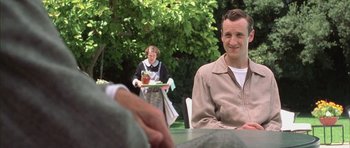 Movie still from “Gods and Monsters” (1998), directed by Bill Condon – A man sitting at a table with a tray in front of a woman; Medium shot, Over the shoulder angle