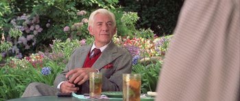 Movie still from “Gods and Monsters” (1998), directed by Bill Condon – An older man sitting at a table in a garden; Medium shot, Over the shoulder angle