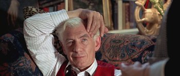 Movie still from “Gods and Monsters” (1998), directed by Bill Condon – An older man with white hair and wearing a red vest; Close Up shot, High angle