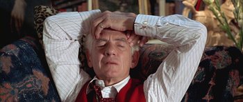 Movie still from “Gods and Monsters” (1998), directed by Bill Condon – An older man is laying down with his hands behind his head; Close Up shot, High angle