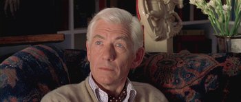 Movie still from “Gods and Monsters” (1998), directed by Bill Condon – An older man sitting in a chair with his eyes wide open; Close Up shot, High angle