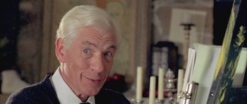 Movie still from “Gods and Monsters” (1998), directed by Bill Condon – An older man with white hair sitting in front of candles; Close Up shot, Over the shoulder angle