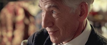 Movie still from “Gods and Monsters” (1998), directed by Bill Condon – An older man with white hair and blue eyes looking at the camera; Extreme Close Up shot, Over the shoulder angle
