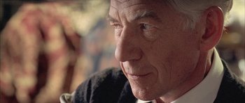 Movie still from “Gods and Monsters” (1998), directed by Bill Condon – An older man looking into the distance with a serious look; Close Up shot, Over the shoulder angle