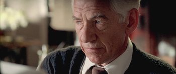 Movie still from “Gods and Monsters” (1998), directed by Bill Condon – An older man wearing a suit and tie looking at the camera; Close Up shot, Low angle