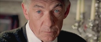 Movie still from “Gods and Monsters” (1998), directed by Bill Condon – An older man with blue eyes stares at the camera; Extreme Close Up shot, Over the shoulder angle