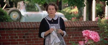 Movie still from “Gods and Monsters” (1998), directed by Bill Condon – An older woman holding a dish towel in her hands; Medium shot, Low angle