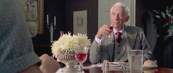 Movie still from “Gods and Monsters” (1998), directed by Bill Condon – An older man sitting at a table with a glass of wine; Close Up shot, Over the shoulder angle