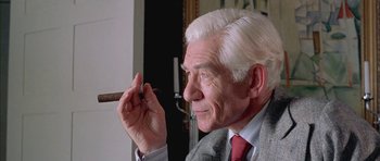 Movie still from “Gods and Monsters” (1998), directed by Bill Condon – An older man holding a cigar in his right hand; Close Up shot, Low angle