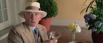 Movie still from “Gods and Monsters” (1998), directed by Bill Condon – An older man wearing a hat and holding a martini glass; Close Up shot, Low angle