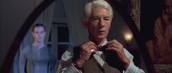 Movie still from “Gods and Monsters” (1998), directed by Bill Condon – An older man adjusts his bow tie in front of a mirror; Close Up shot, Over the shoulder angle