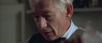 Movie still from “Gods and Monsters” (1998), directed by Bill Condon – An older man in a suit looking down at his face; Close Up shot, Low angle