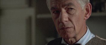 Movie still from “Gods and Monsters” (1998), directed by Bill Condon – An older man in a suit and tie looking at the camera; Close Up shot, Low angle