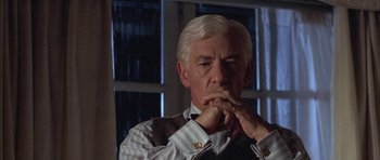 Movie still from “Gods and Monsters” (1998), directed by Bill Condon – An older man with white hair is looking at the camera; Close Up shot, Over the shoulder angle